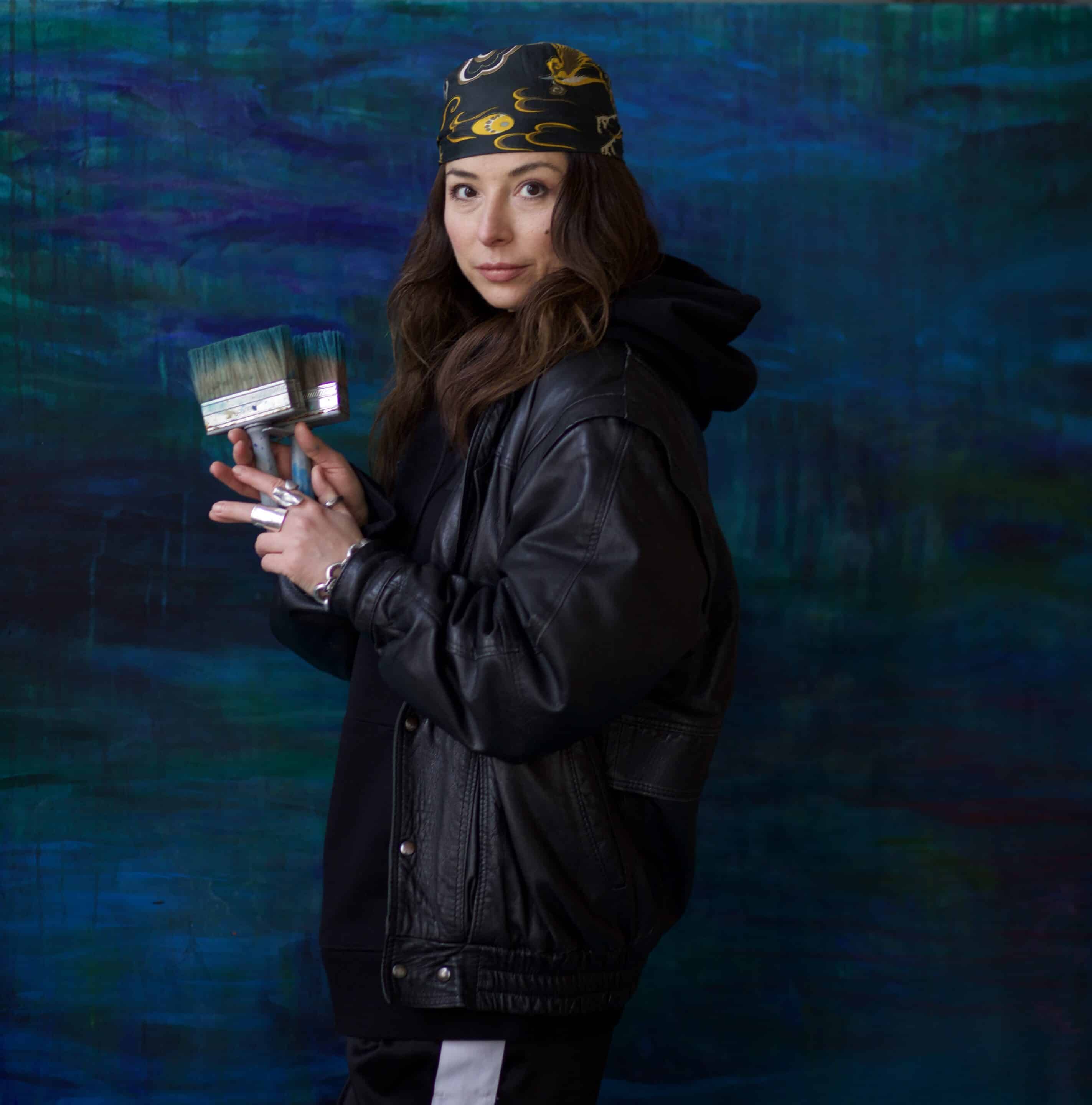 ganna ki standing in front of her artwork